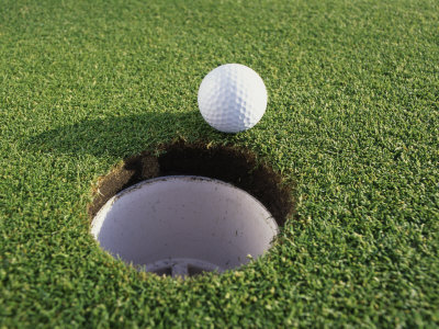 a golf ball at the hole
